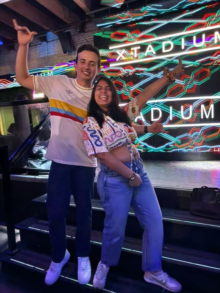 Nicolas and a classmate posing in front of the Xtadium stage.