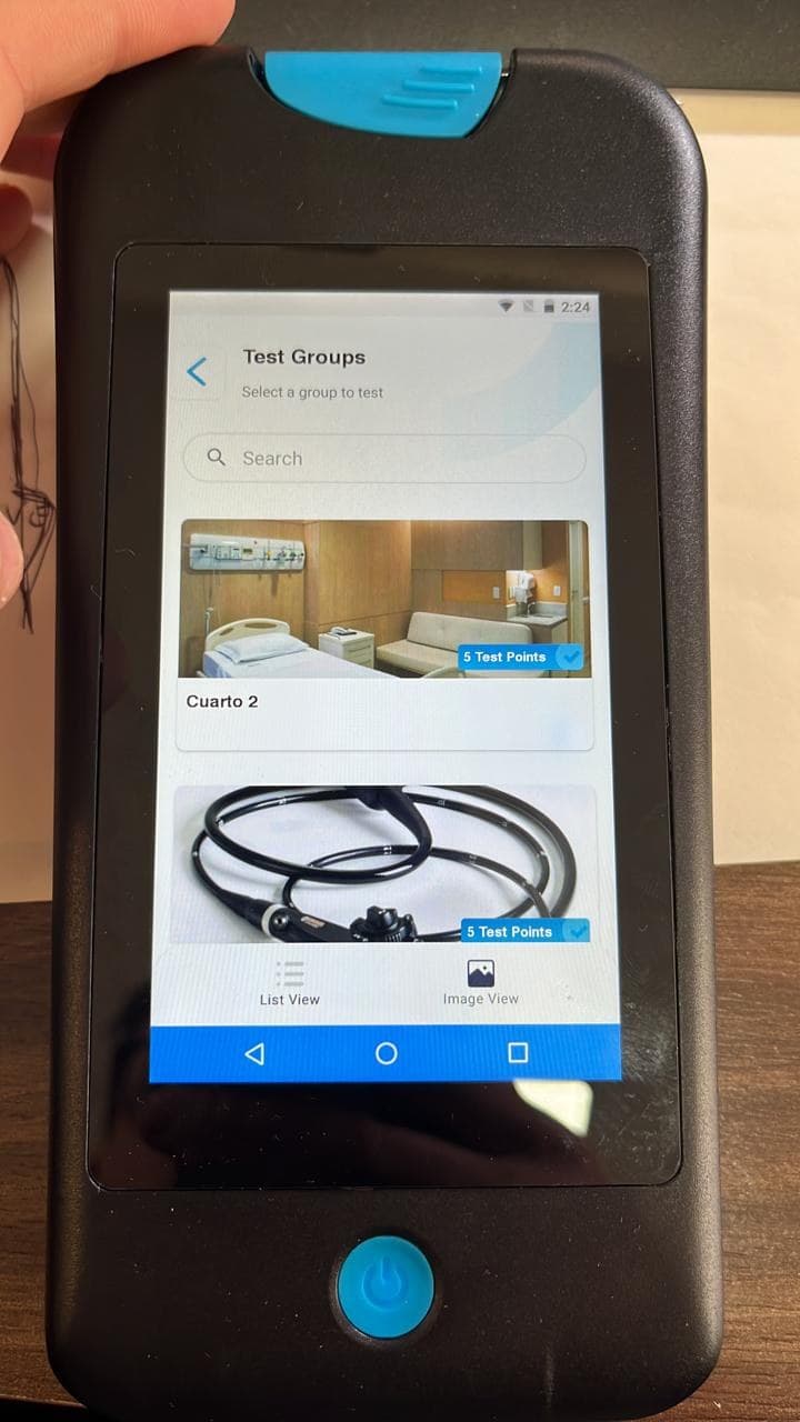 Handheld ATP Complete 2 device showing test groups in an image-based interface.